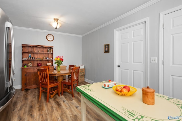 dining room featuring hardwood / wood-style flooring and ornamental molding