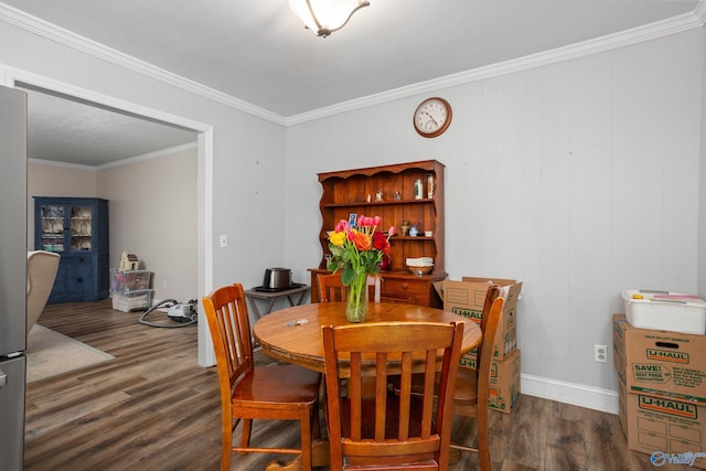 dining space with ornamental molding and dark wood-type flooring