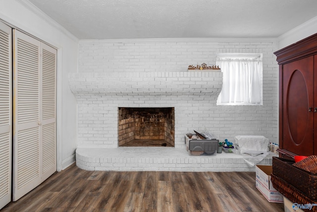 unfurnished living room featuring crown molding, a brick fireplace, and dark hardwood / wood-style floors