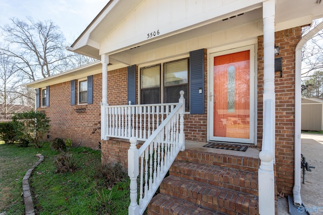 view of exterior entry featuring covered porch