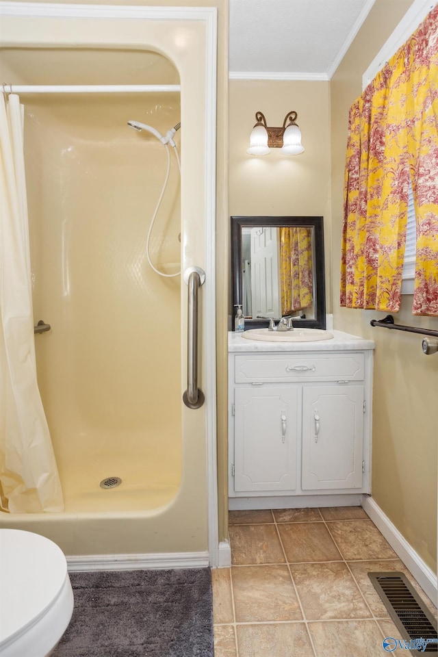 bathroom featuring ornamental molding, vanity, a shower with shower curtain, and toilet