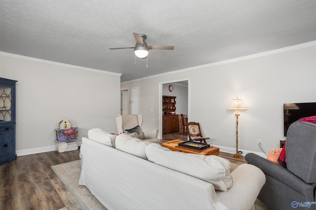 living room featuring dark hardwood / wood-style flooring, ornamental molding, and ceiling fan