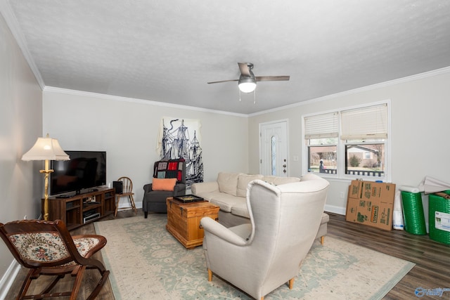 living room with a textured ceiling, crown molding, ceiling fan, and wood-type flooring