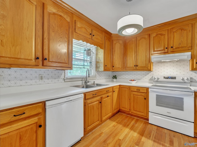 1011 Cole Dr SE, Huntsville, AL 35802 - kitchen featuring white appliances, under cabinet range hood, light wood-style floors, light countertops, and tasteful backsplash