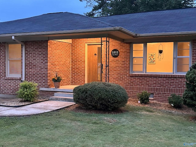 1011 Cole Dr SE, Huntsville, AL 35802 - view of front of house featuring brick siding, roof with shingles, and a front lawn