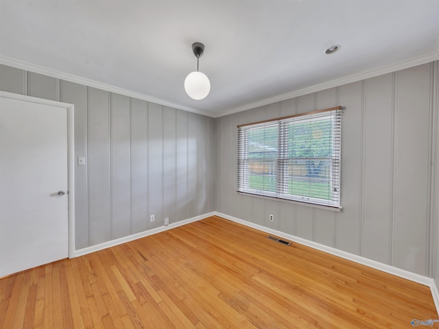 1011 Cole Dr SE, Huntsville, AL 35802 - unfurnished room with a decorative wall, light wood-style floors, and ornamental molding