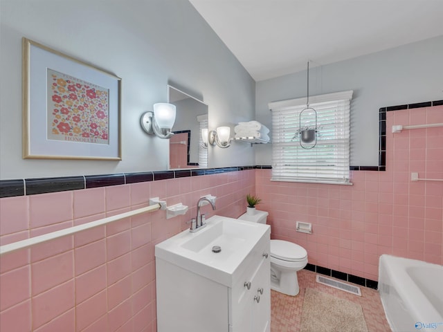 1011 Cole Dr SE, Huntsville, AL 35802 - full bath featuring tile walls, vanity, tile patterned floors, a bath, and wainscoting