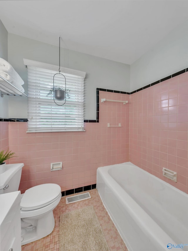 1011 Cole Dr SE, Huntsville, AL 35802 - full bath with a garden tub, tile walls, vanity, and wainscoting