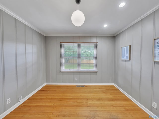 1011 Cole Dr SE, Huntsville, AL 35802 - empty room with light wood-type flooring, crown molding, a decorative wall, and recessed lighting