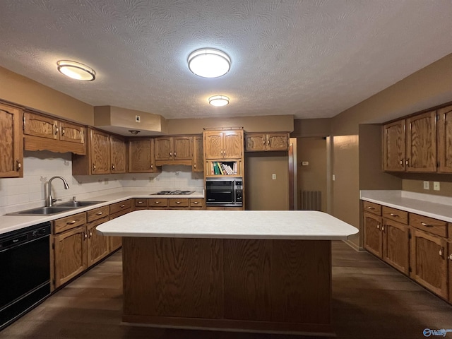 kitchen with stainless steel gas stovetop, black dishwasher, a sink, dark wood-type flooring, and brown cabinets