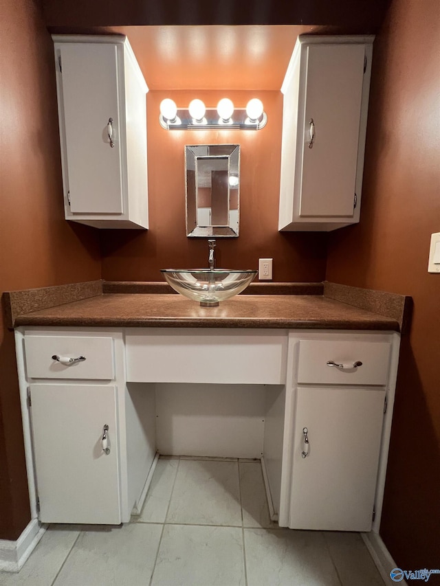 bathroom with tile patterned floors and vanity