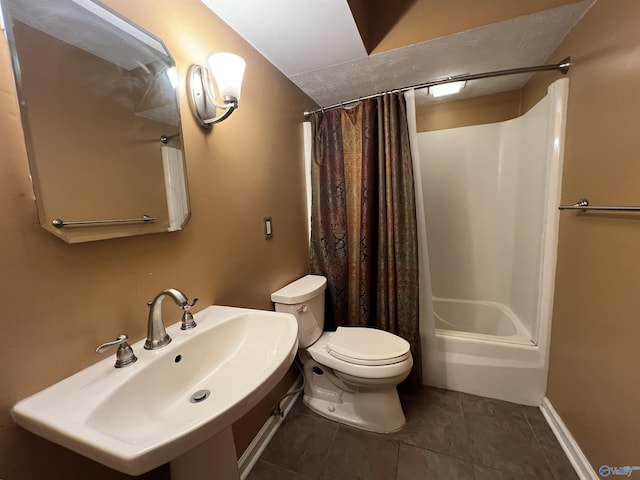 bathroom with toilet, tile patterned flooring, a sink, and shower / tub combo with curtain