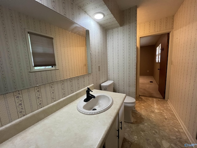 bathroom featuring toilet and vanity