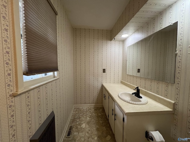 bathroom featuring vanity and baseboards