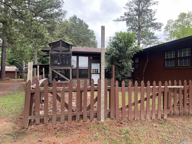 view of front facade featuring exterior structure and fence
