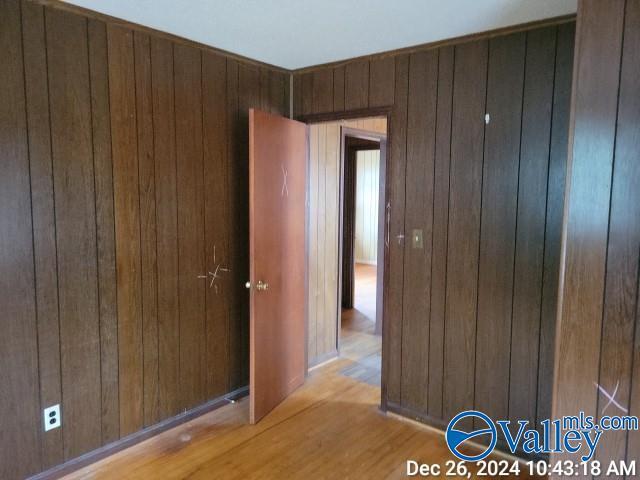 interior space with wood walls and light wood-type flooring