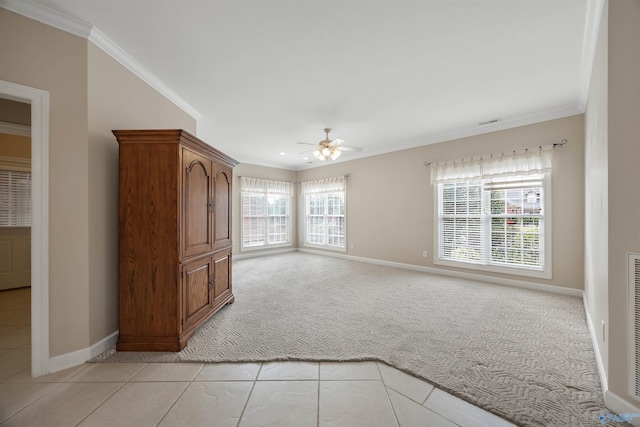 unfurnished living room featuring ornamental molding, plenty of natural light, light carpet, and ceiling fan