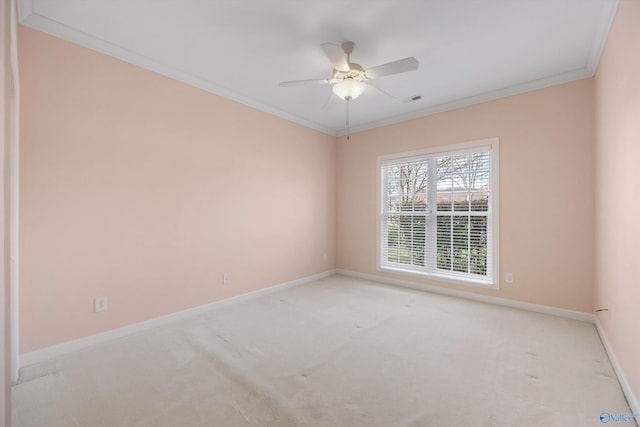 carpeted empty room featuring crown molding and ceiling fan