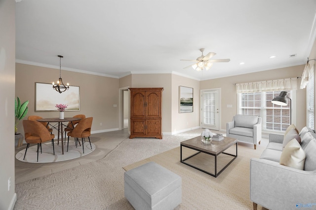 carpeted living room featuring ceiling fan with notable chandelier and ornamental molding