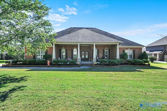 view of front facade with covered porch and a front lawn