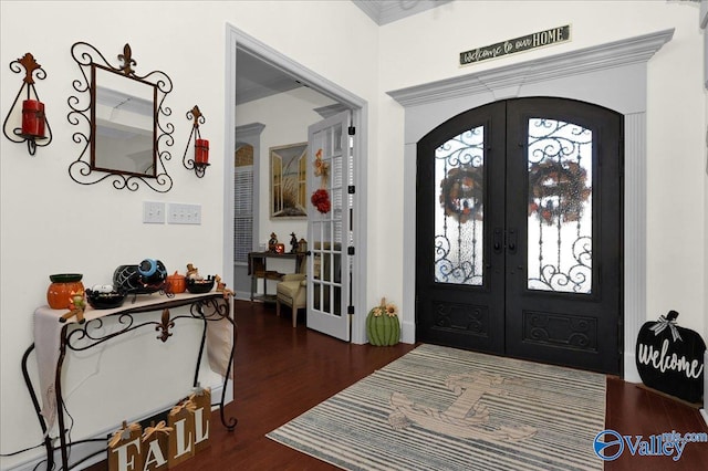 foyer with french doors and dark hardwood / wood-style floors