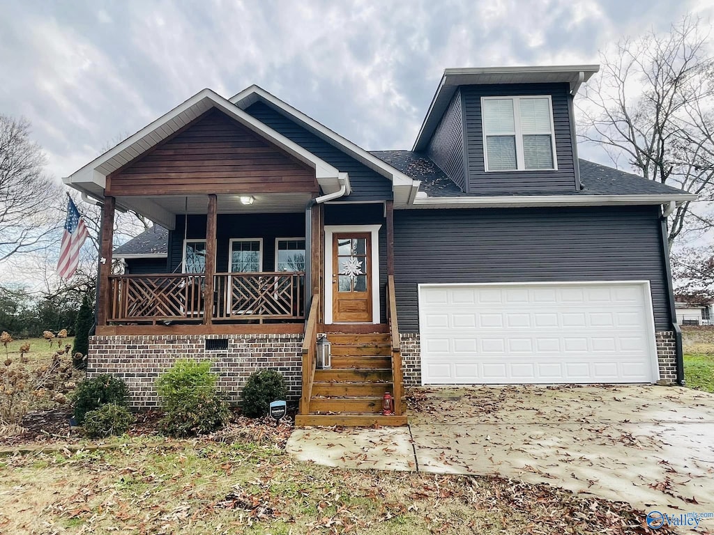 view of front of house featuring a porch and a garage