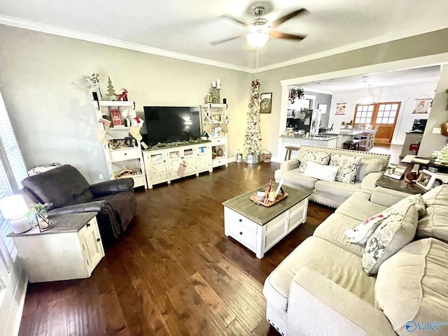 living room featuring dark hardwood / wood-style flooring, ceiling fan, and ornamental molding