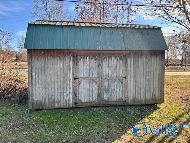 view of outbuilding featuring a lawn