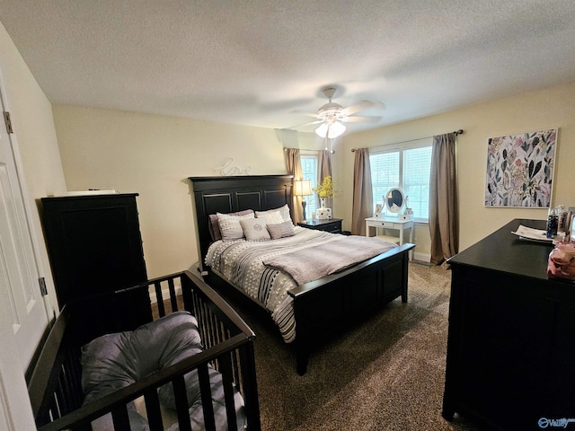 carpeted bedroom featuring ceiling fan and a textured ceiling