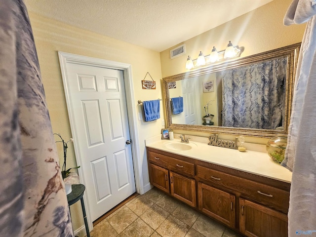 bathroom featuring vanity and a textured ceiling