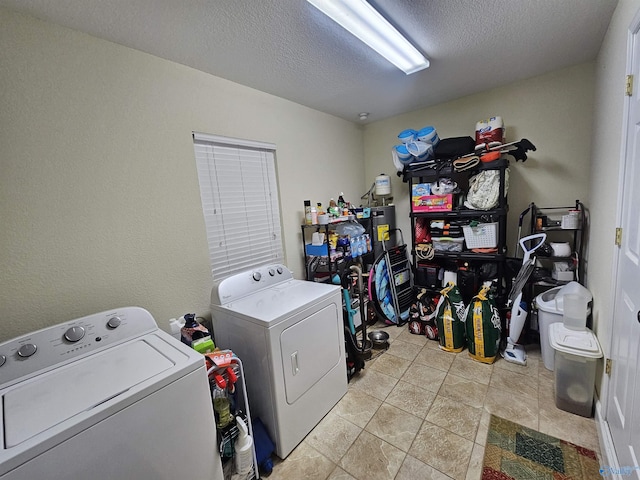 laundry room with washing machine and clothes dryer and a textured ceiling