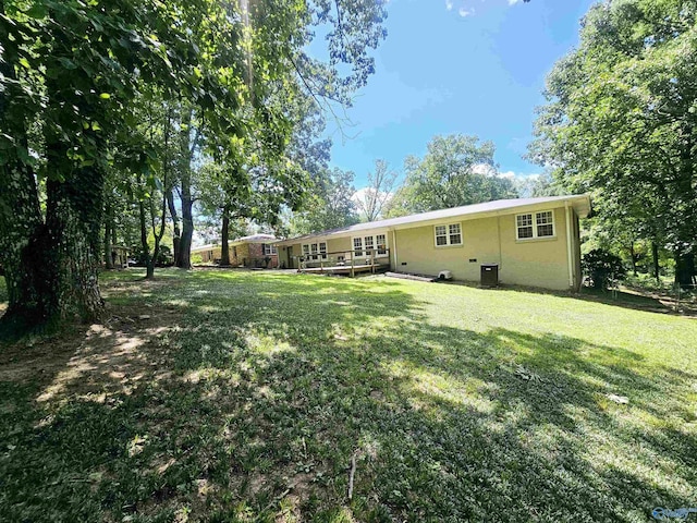 rear view of property featuring a yard