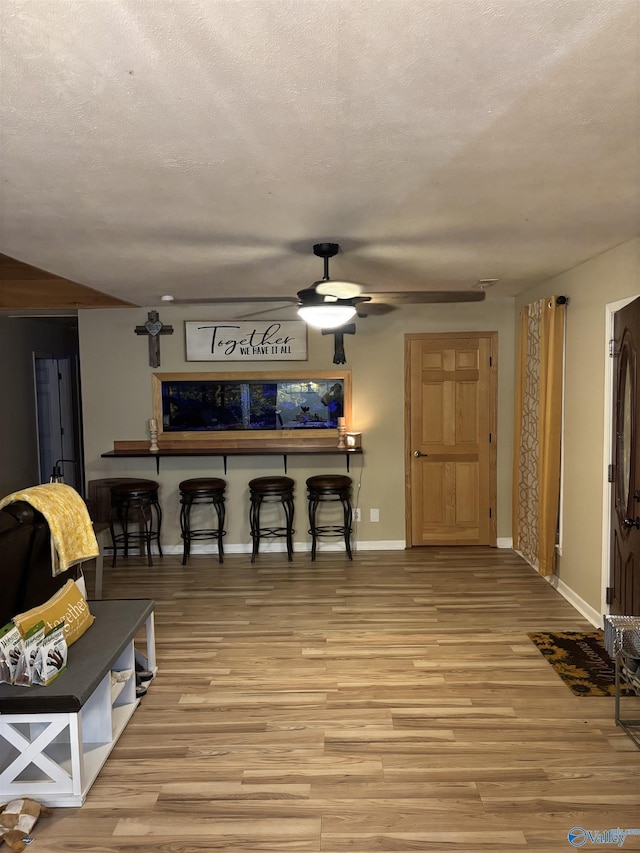 living room featuring a textured ceiling and light wood-type flooring