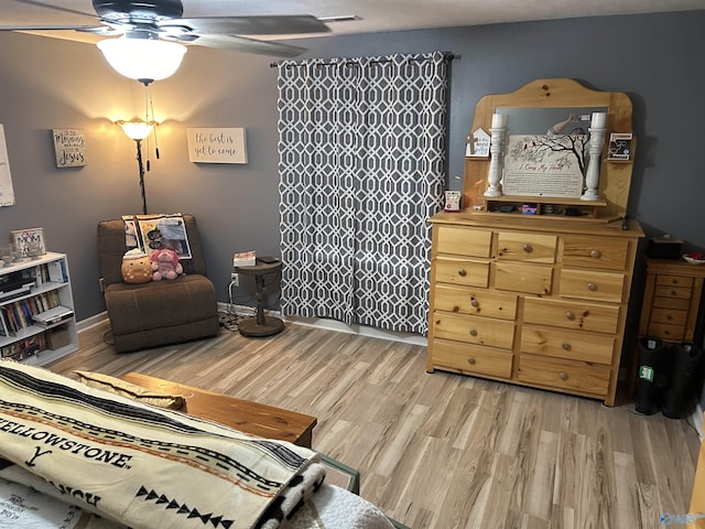 sitting room with ceiling fan and light hardwood / wood-style floors