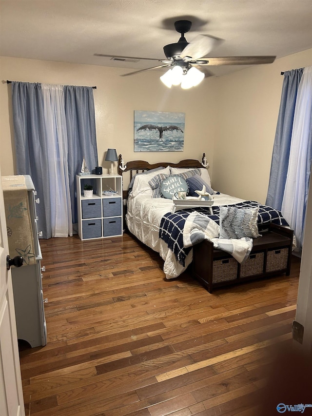 bedroom with dark wood-type flooring and ceiling fan