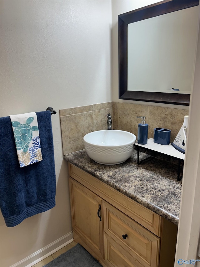 bathroom featuring vanity, tile patterned flooring, and decorative backsplash