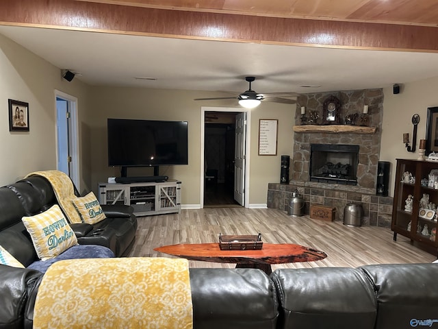 living room featuring ceiling fan, a fireplace, and hardwood / wood-style floors