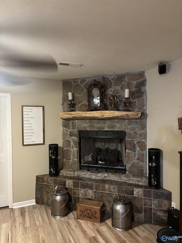 interior details featuring hardwood / wood-style flooring and a fireplace