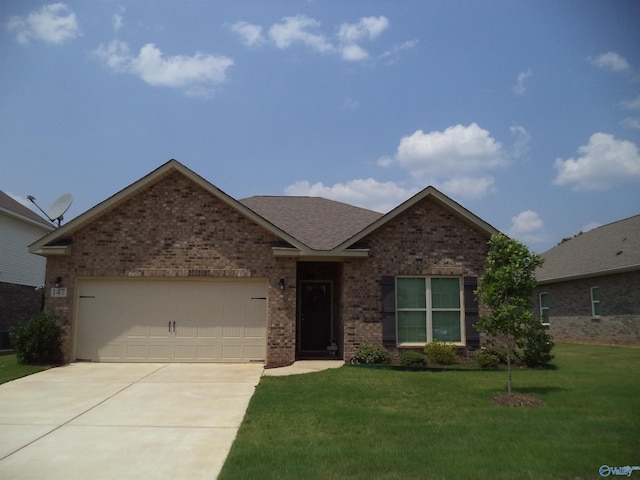 147 Cherry Laurel Dr, Hazel Green, AL 35750 - ranch-style home featuring brick siding, concrete driveway, a front lawn, an attached garage, and roof with shingles