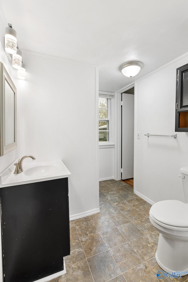 bathroom featuring vanity and toilet