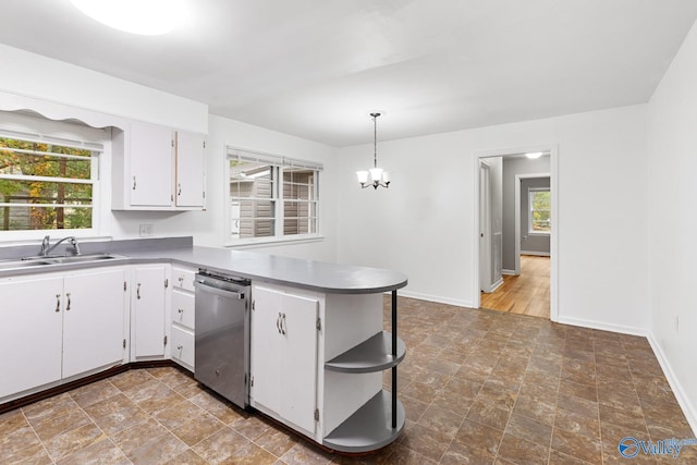 kitchen featuring dishwasher, sink, white cabinets, and hanging light fixtures