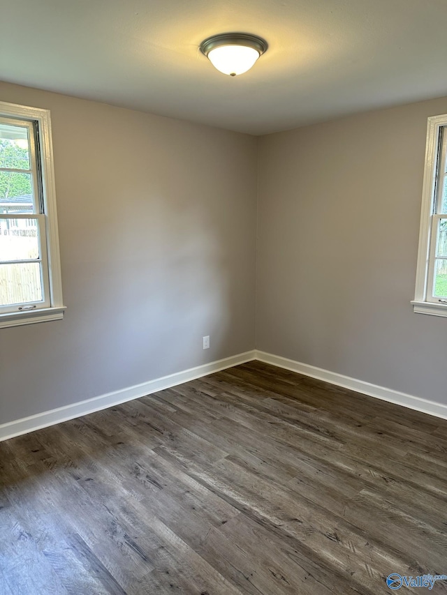 2022 Bide A Wee Dr NE, Huntsville, AL 35801 - unfurnished room with dark wood-style floors, healthy amount of natural light, and baseboards