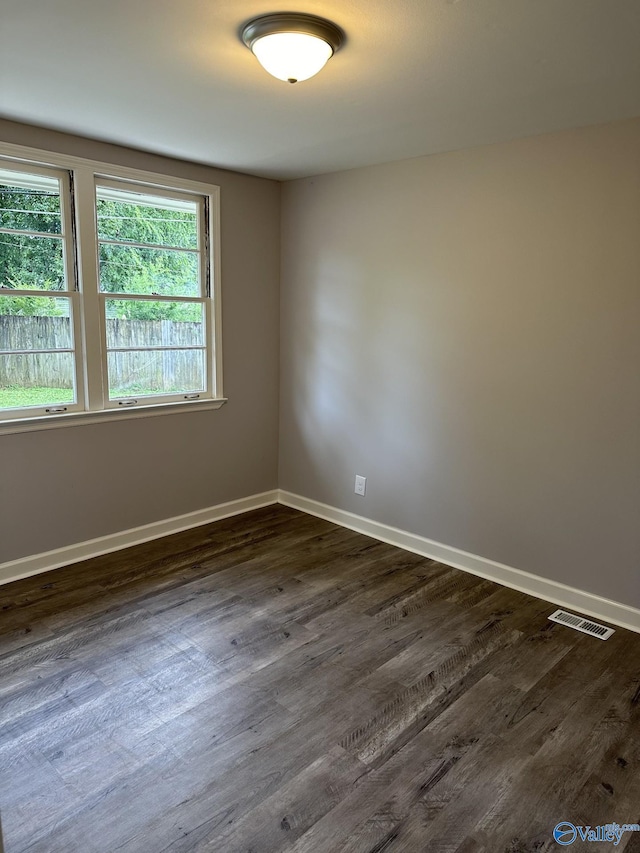 2022 Bide A Wee Dr NE, Huntsville, AL 35801 - spare room featuring dark wood-style floors and baseboards