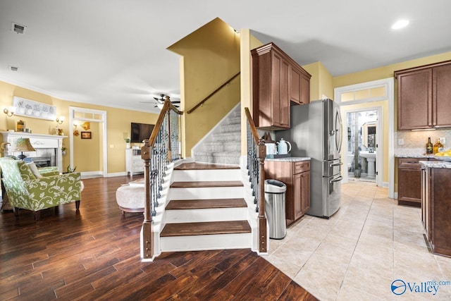 126 Mattie Ct, Madison, AL 35756 - stairs featuring crown molding, wood finished floors, ceiling fan, and a fireplace