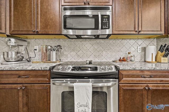 126 Mattie Ct, Madison, AL 35756 - kitchen featuring appliances with stainless steel finishes, decorative backsplash, and light stone countertops