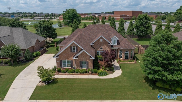 126 Mattie Ct, Madison, AL 35756 - view of front facade with brick siding, a front lawn, a residential view, and concrete driveway