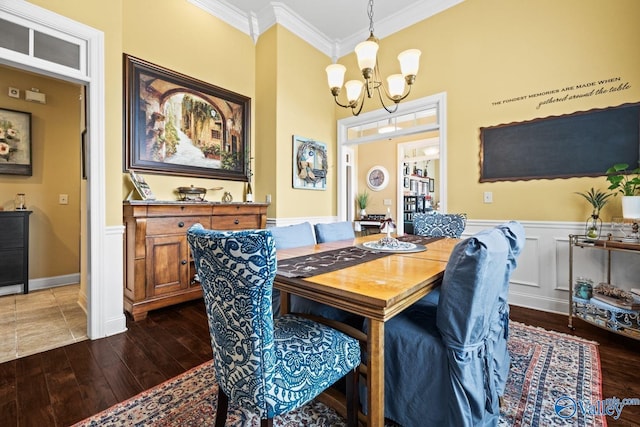 126 Mattie Ct, Madison, AL 35756 - dining space with a chandelier, crown molding, dark wood-style floors, and wainscoting