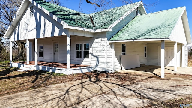 back of house with a carport and a porch