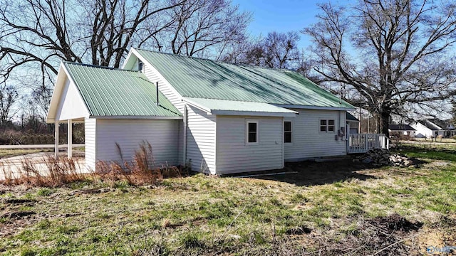 view of home's exterior featuring a yard and a deck