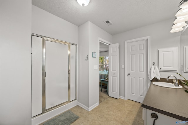 170 Jarrett Ln, Madison, AL 35758 - ensuite bathroom with a stall shower, vanity, and a textured ceiling